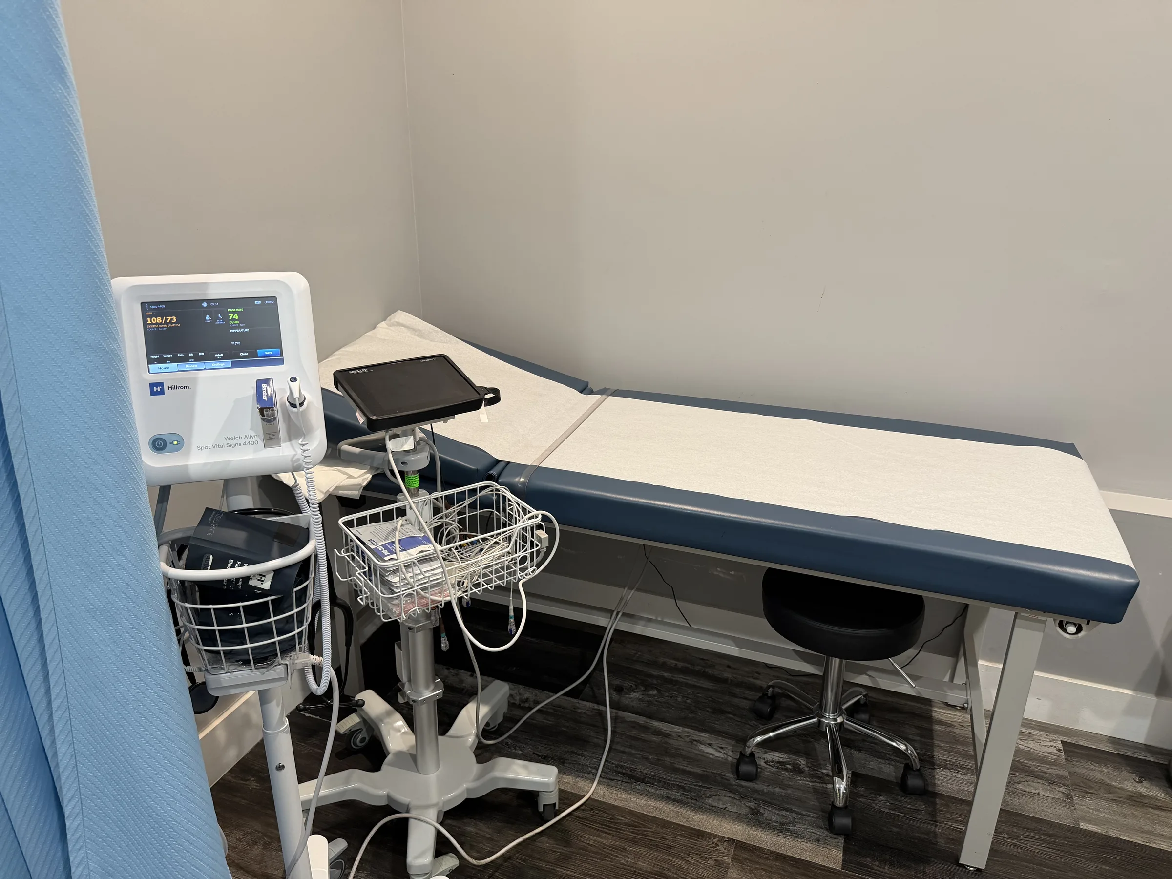 Exam table and measurement equipment inside an exam room.